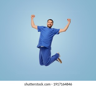 healthcare, profession and medicine concept - happy smiling doctor or male nurse in uniform jumping in air over blue background - Powered by Shutterstock