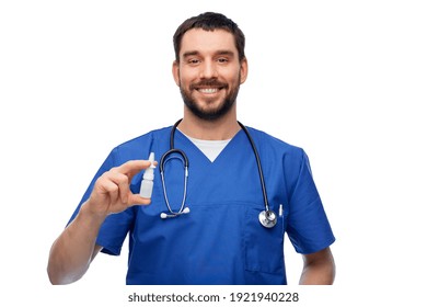 Healthcare, Profession And Medicine Concept - Happy Smiling Doctor Or Male Nurse In Blue Uniform With Nasal Spray And Stethoscope Over White Background