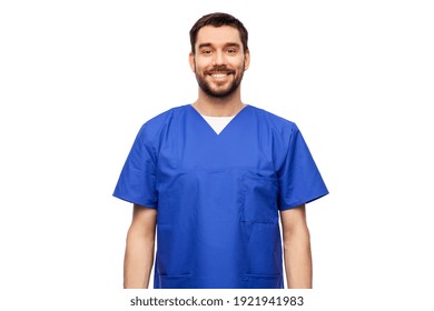 Healthcare, Profession And Medicine Concept - Happy Smiling Doctor Or Male Nurse In Blue Uniform Over White Background