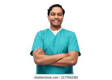 healthcare, profession and medicine concept - happy smiling indian doctor or male nurse in blue uniform with crossed arms over white background - Shutterstock ID 2177042381