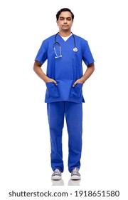 Healthcare, Profession And Medicine Concept - Indian Doctor Or Male Nurse In Blue Uniform With Stethoscope Over White Background