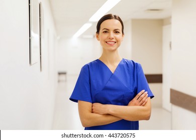 healthcare, profession, people and medicine concept - happy doctor or nurse at hospital corridor - Powered by Shutterstock