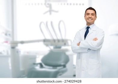 healthcare, profession, stomatology and medicine concept - smiling male middle aged dentist over medical office background - Powered by Shutterstock