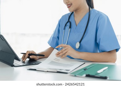 Healthcare Professional Analyzing Patient Data on Digital Tablet - Powered by Shutterstock