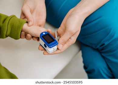 Healthcare professional checking childs vitals with a pulse oximeter for accurate monitoring - Powered by Shutterstock