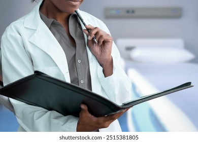 A healthcare professional, dressed in a white lab coat, is thoughtfully reviewing a patient’s medical chart while holding a pen, indicating careful analysis and decision-making in a clinical setting. - Powered by Shutterstock