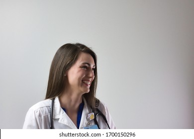 Healthcare Professional Head Shot Up Close Isolated On Grey Background. Medical Portrait Of Female Doctor Or Nurse Practitioner