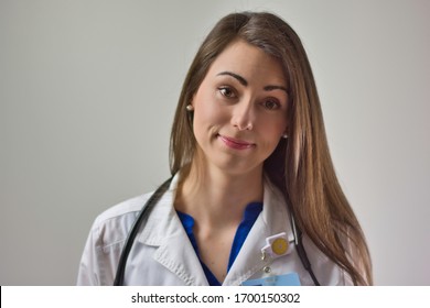 Healthcare Professional Head Shot Up Close Isolated On Grey Background. Medical Portrait Of Female Doctor Or Nurse Practitioner