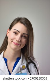 Healthcare Professional Head Shot Up Close Isolated On Grey Background. Medical Portrait Of Female Doctor Or Nurse Practitioner