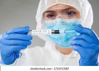 Healthcare Professional Holding Coronavirus COVID-19 Test Kit Equipment,patient Swab Sample Examination Analysis,lab Scientist In Hazmat Personal Protective Suit Inspecting Sterile DNA Specimen Tube 