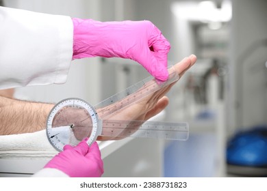 Healthcare Professional Measuring Joint Range of Motion with a Goniometer - Powered by Shutterstock