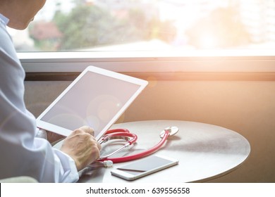 Healthcare Professional Medical Doctor Using Tablet And Smartphone For Consult Patient Via Online: Physician Working Tele-consultation: Hospital E-healthcare Professionalism Digital Health Concept.