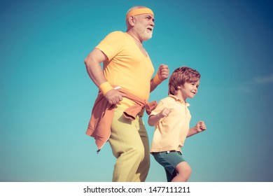 Healthcare Run Lifestyle. Grandfather And Grandson Jogging. Senior Man And Child In Family Health Club