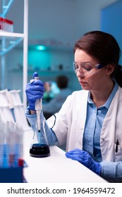 Healthcare Scientist Using Laboratory Dropper Micropipette During Vaccine Engineering. Woman Research A New Experiment In Modern Lab, Analyzing Pharmaceutical Work With Modern Equipment.