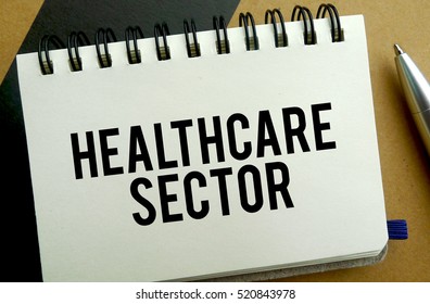 Healthcare Sector Memo Written On A Notebook With Pen