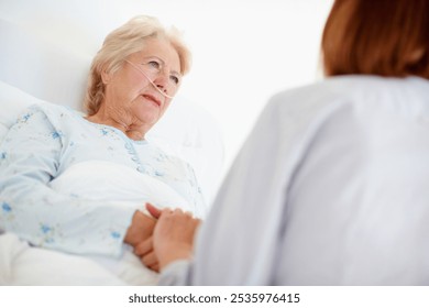 Healthcare, senior woman and doctor with support for recovery, compassion and consultation in bed. Hospital, sick elderly patient and caregiver with oxygen tube for pneumonia, asthma or holding hands - Powered by Shutterstock