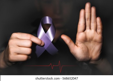 Healthcare And Social Problem Concept - Child Hands Holding Purple Domestic Violence Awareness Ribbon