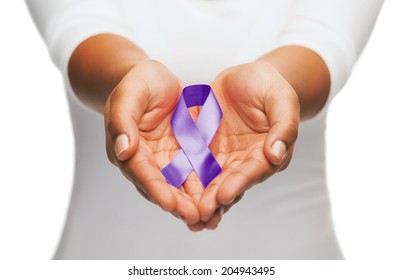 Healthcare And Social Problem Concept - Womans Hands Holding Purple Domestic Violence Awareness Ribbon