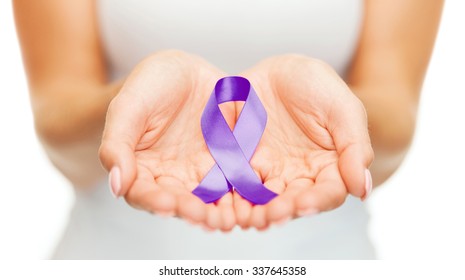 Healthcare And Social Problems Concept - Womans Hands Holding Purple Domestic Violence Awareness Ribbon