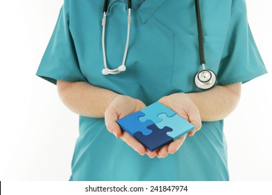 Healthcare Solutions - Nurse Holding A Completed Jigsaw Puzzle