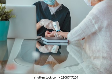 Healthcare Specialist Checking Elderly Patient At Home