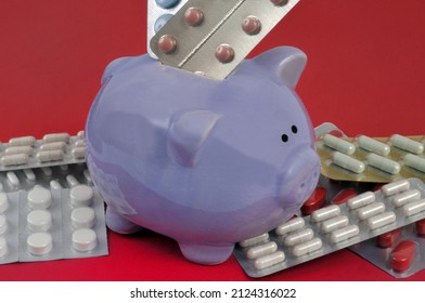 Healthcare Spending Concept With Medicine Blister Packs In Piggy Bank On Red Background