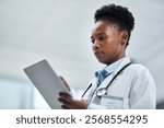 Healthcare, technology and black woman with tablet for online patient report, results review and diagnosis. African doctor, medical research and communication in hospital, clinic or health facility