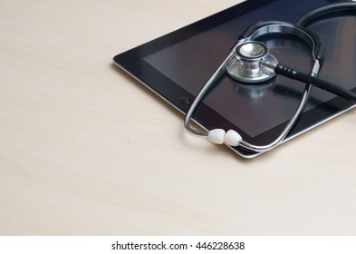 Healthcare And Technology Concept - Tablet  And Stethoscope 