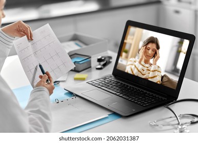 healthcare, technology and medicine concept - female doctor with laptop computer and cardiogram having video call with sick woman patient having headache at hospital