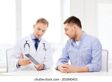 Healthcare, Technology And Medicine Concept - Serious Doctor With Tablet Pc Computer And Patient In Hospital