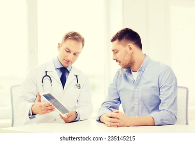 Healthcare, Technology And Medicine Concept - Serious Doctor With Tablet Pc Computer And Patient In Hospital