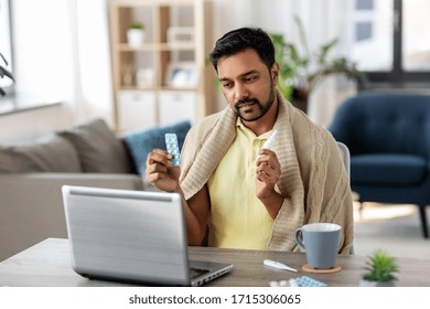 Healthcare, Technology And People Concept - Sick Indian Man In Blanket With Thermometer Having Video Call On Laptop Computer At Home