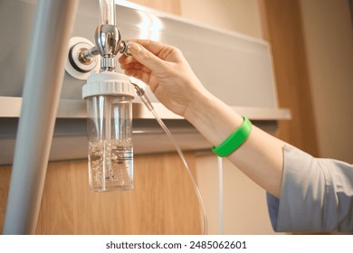 Healthcare worker adjusts an oxygenation machine - Powered by Shutterstock