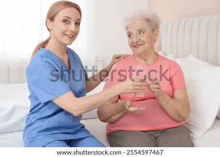 Similar – Female doctor giving medication to elderly patient