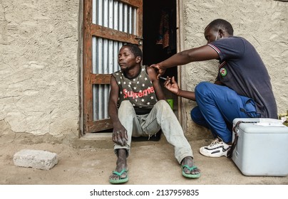 A healthcare worker injects a dose of Sinopharm against the Covid-19, during a door to door vaccination session at Mtopwa village in Nanyamba town council, Mtwara region, Tanzania on February 26, 2022