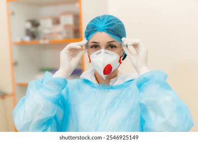 Healthcare worker in protective gear. A healthcare worker adjusts their protective mask and goggles, readying for medical tasks in a clinical setting. - Powered by Shutterstock