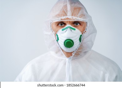 Healthcare Worker In Protective Suit And Medical Mask On White Background. Health Care Concept.