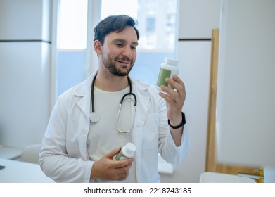 Healthcare Worker Reading The Label On The Dietary Supplement