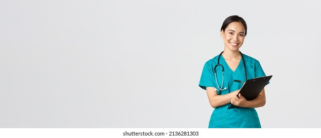 Healthcare Workers, Preventing Virus, Quarantine Campaign Concept. Cheerful Friendly Asian Female Physician, Doctor With Clipboard During Daily Checkup, Standing White Background