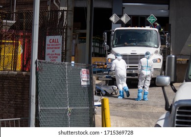 Healthcare Workers Push Hospital Beds After Bringing Deceased Patients To A Temporary Morgue Outside Brooklyn Hospital Center During The Coronavirus Pandemic In New York, The US, April 14, 2020