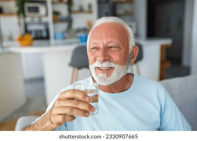 health-conscious senior man upholds his good lifestyle by savoring a glass of water. With each sip, he nourishes his body, exemplifying the significance of hydration and well-being in his golden years - Powered by Shutterstock