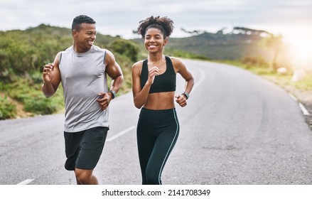 The healthier you are, the happier you feel. Shot of a sporty young couple exercising together outdoors.