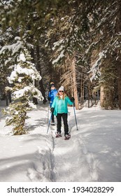 Healthy, Active Female Seniors Snowshoeing In Wyoming. Winter Snow Landscape. Women Friends Trekking In The Snow Together. Snowshoes. 