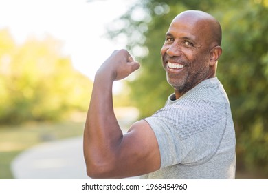 Healthy African American man flexing
and doing a bicep curl
