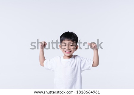 Healthy Asian boy about 4 year olds with strong arm gesture