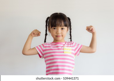 Healthy Asian Child Show Her Arm Muscle