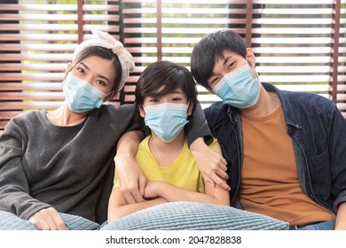 Healthy Asian Family Stay Home,happiness Asian Dad Mom Son Wearing Face Mask Sit Relax Smile Together Stay Strong And Healthy Lifestyle On Sofa In Living Room At Home,stay Home Stay Distancing Concept