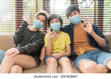 Healthy Asian Family Stay Home,happiness Asian Dad Mom Son Wearing Face Mask Sit Relax Smile Together Stay Strong And Healthy Lifestyle On Sofa In Living Room At Home,stay Home Stay Distancing Concept