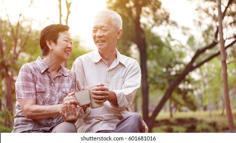 Healthy Asian Senior Elder Couple Drinking Coffee In Morning Park Together