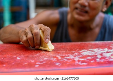 Healthy Asian senior man waxing surfboard surface at home. Active elderly male surfer enjoy outdoor lifestyle surfing at the sea on summer vacation. Retirement people activity and water sport concept. - Powered by Shutterstock